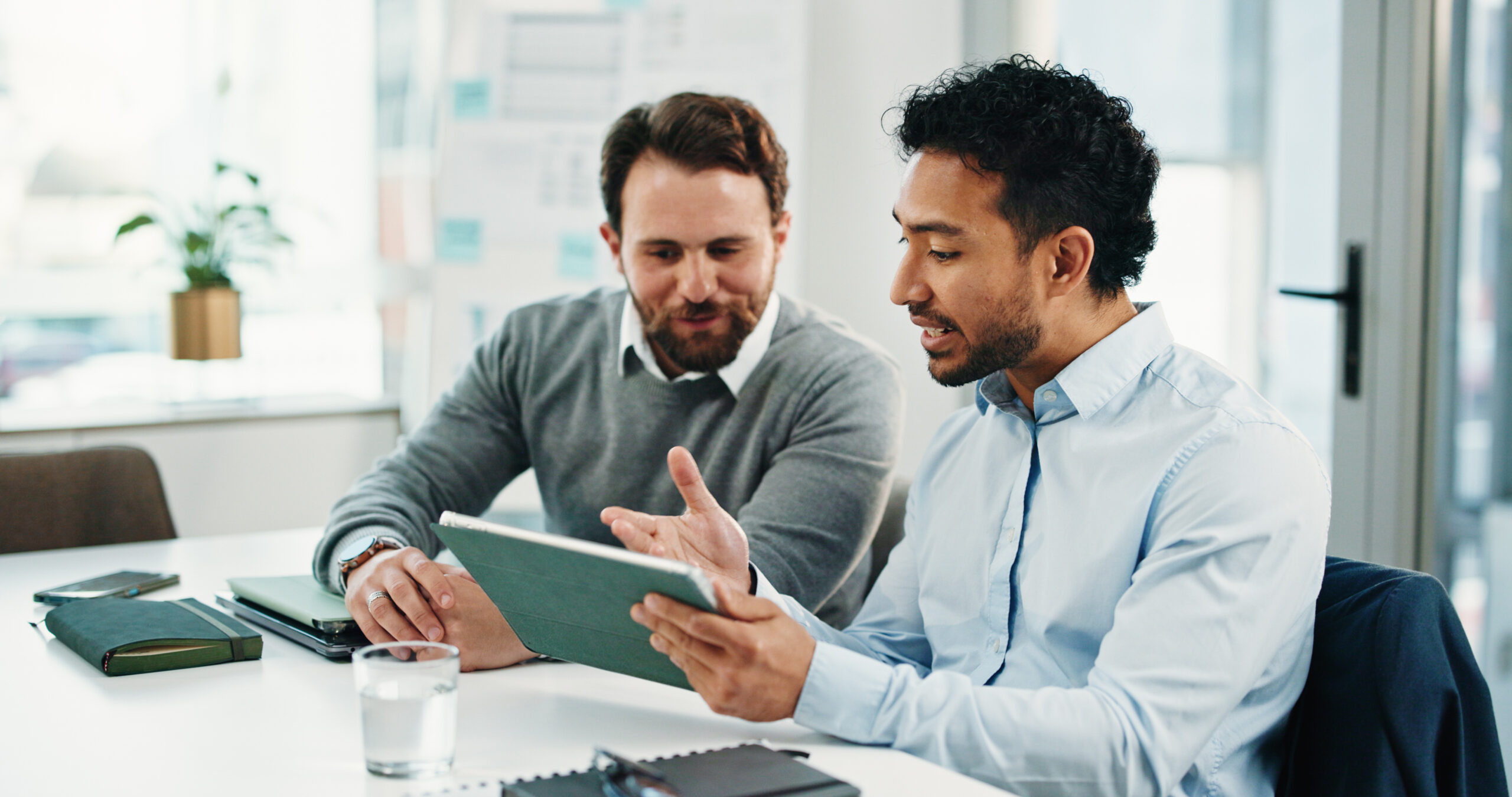 Tablet, team and business men with discussion, insurance proposal or conversation in office. Technology, planning and meeting for idea, risk management and problem solving for policy coverage.