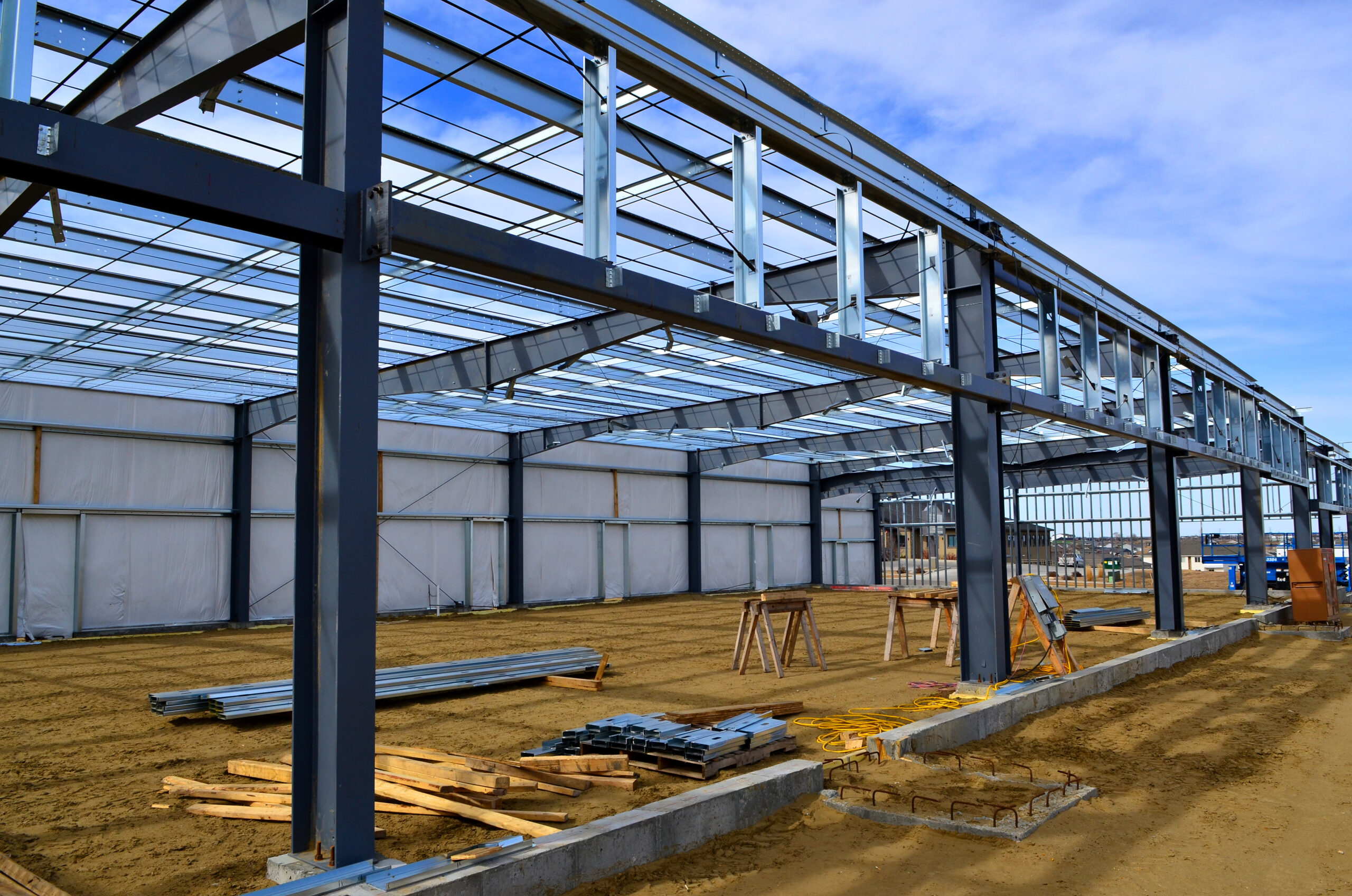 Steel frame commercial building under construction for expanding local business in urban area.