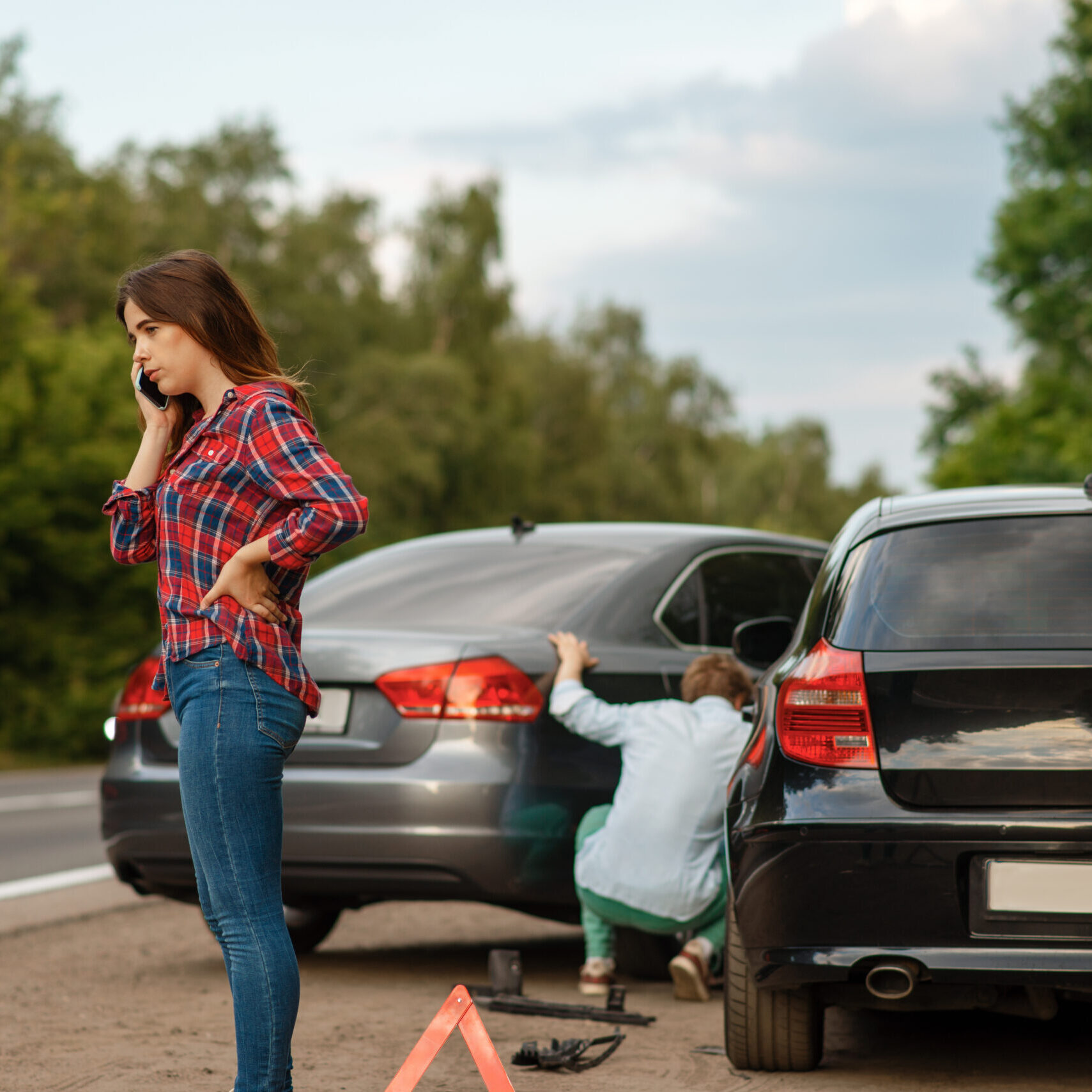 Male and female drivers on road, car accident. Automobile crash. Broken automobile or damaged vehicle, auto collision on highway