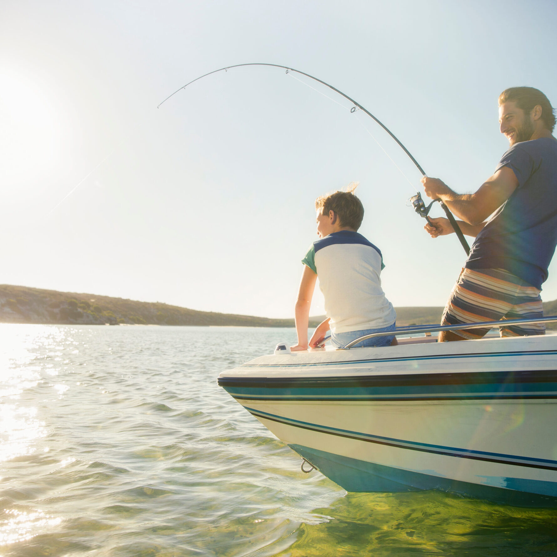 Father and son fishing on boat