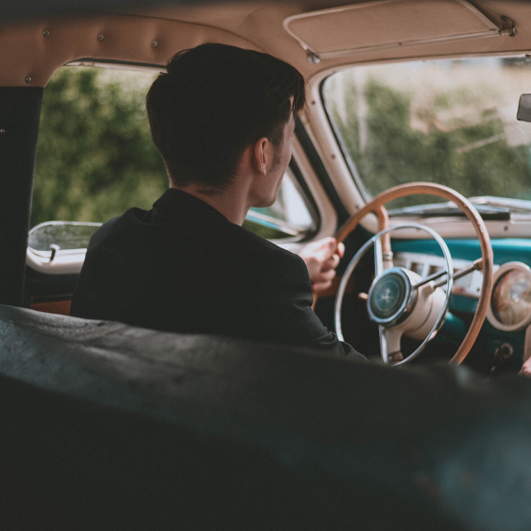 man driving an old car. Retro car salon. Retro photography. Style