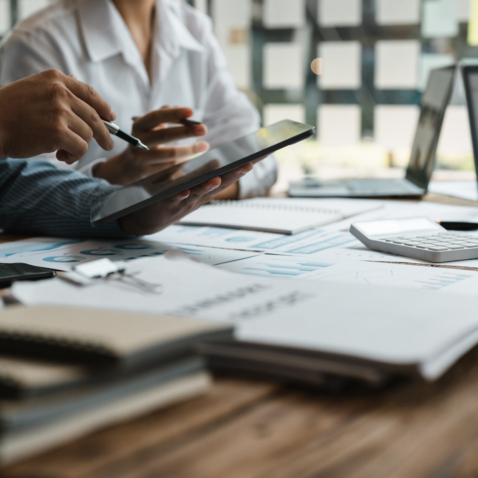 Asian business adviser meeting to analyze and discuss the situation on the financial report in the meeting room.Investment Consultant,Financial Consultant,Financial advisor and accounting concept.