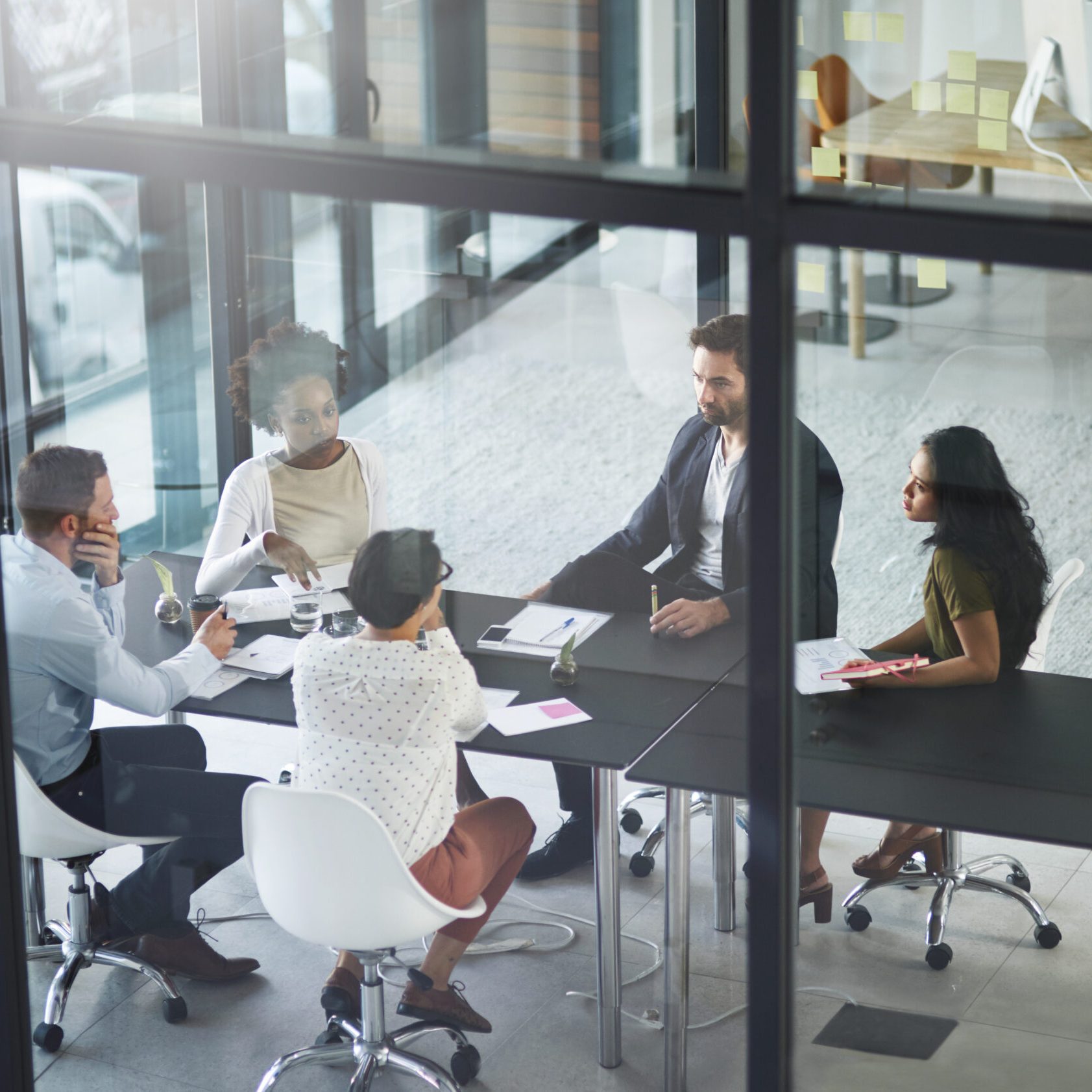 Business people, meeting and above with teamwork in office, talk and feedback for project. Employees, consultant or coworkers with review, communication or development for company and brainstorming.